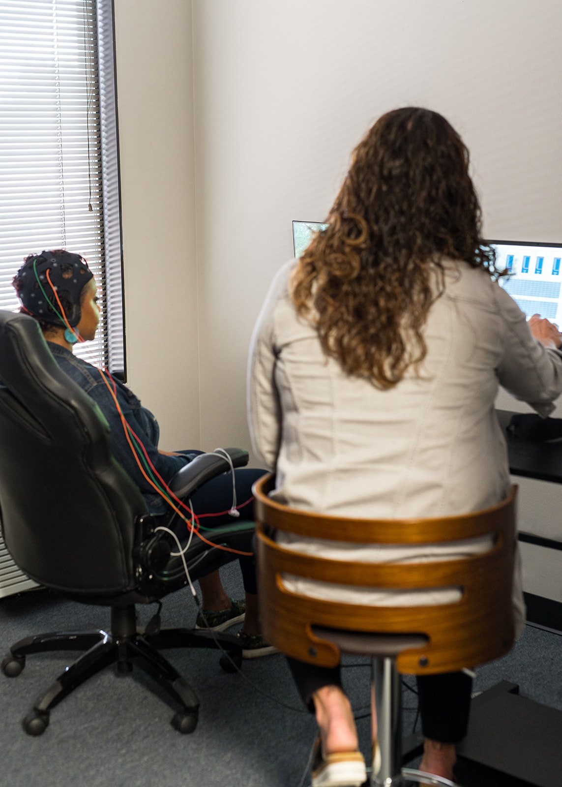Neurofeedback session with EEG sensors and live brainwave data on screen